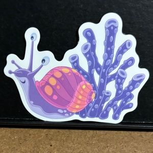 OCEAN SNAIL IN SHELL WITH PURPLE PLANT